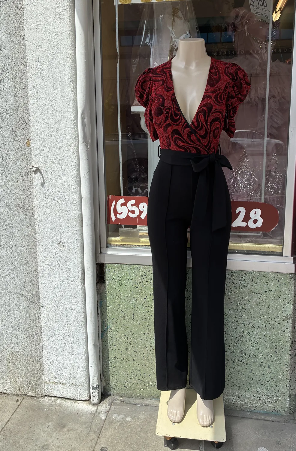 Burgundy lace top & wide-leg trousers displayed on a mannequin