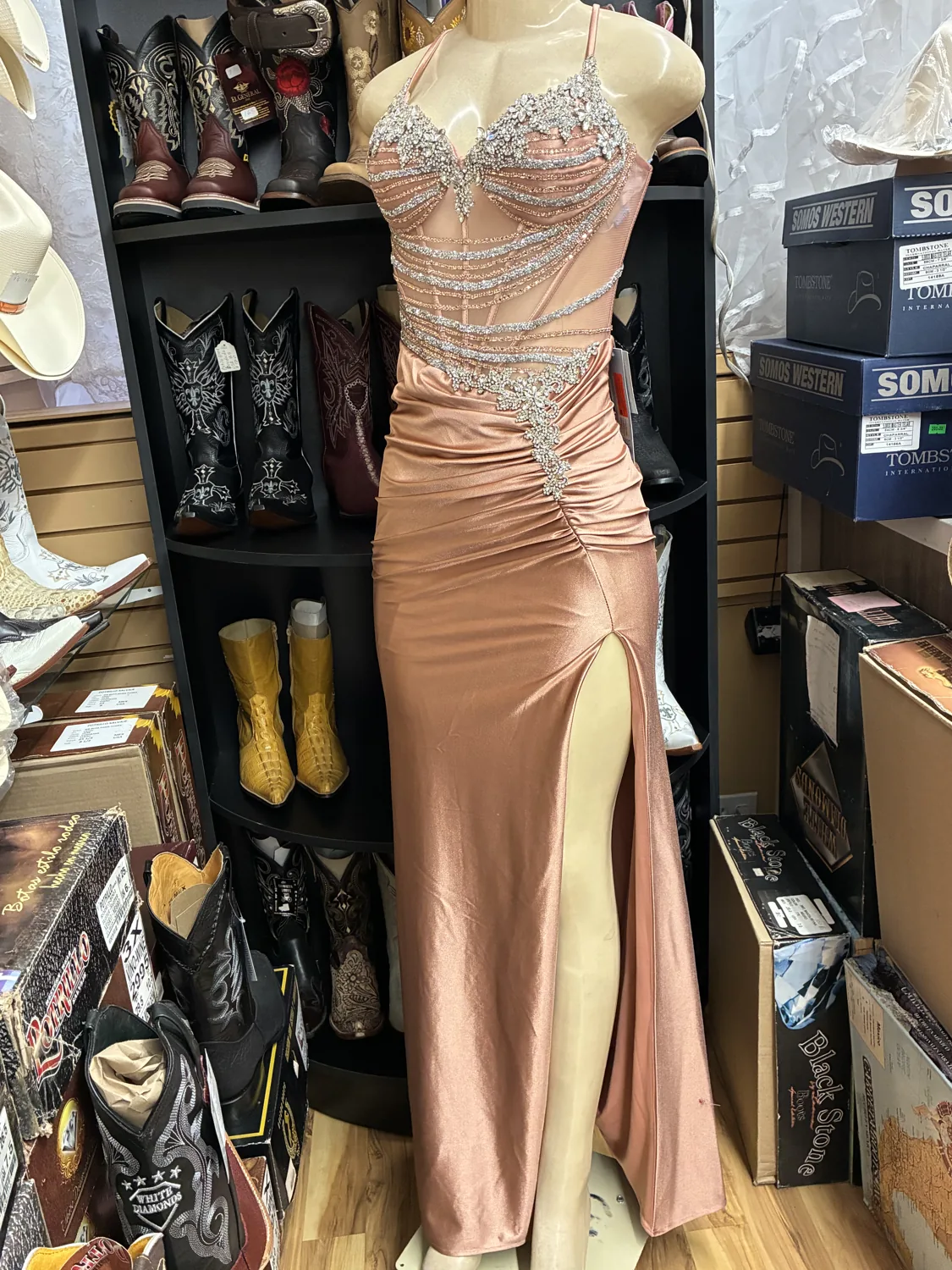 Rose-gold beaded evening gown displayed on a mannequin