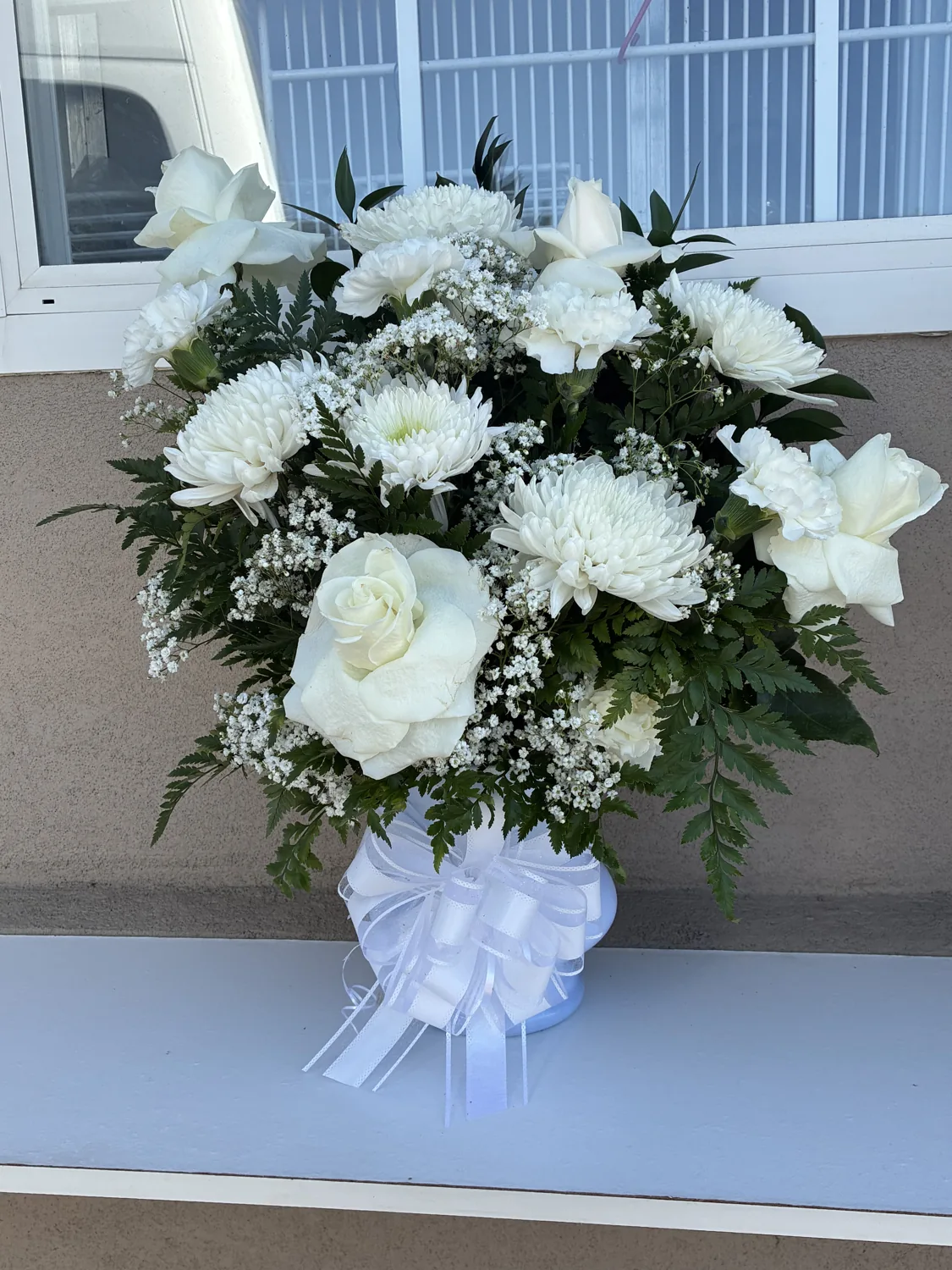 White floral pedestal arrangement