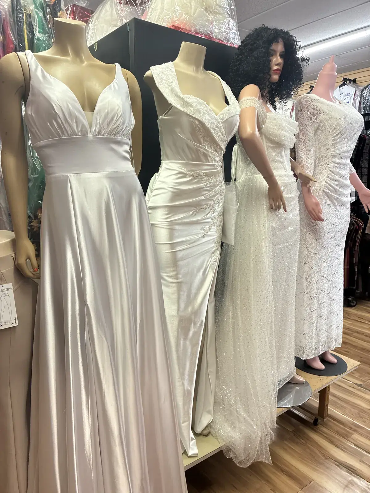 Satin & lace wedding gowns on display at Yessenia’s Fashion