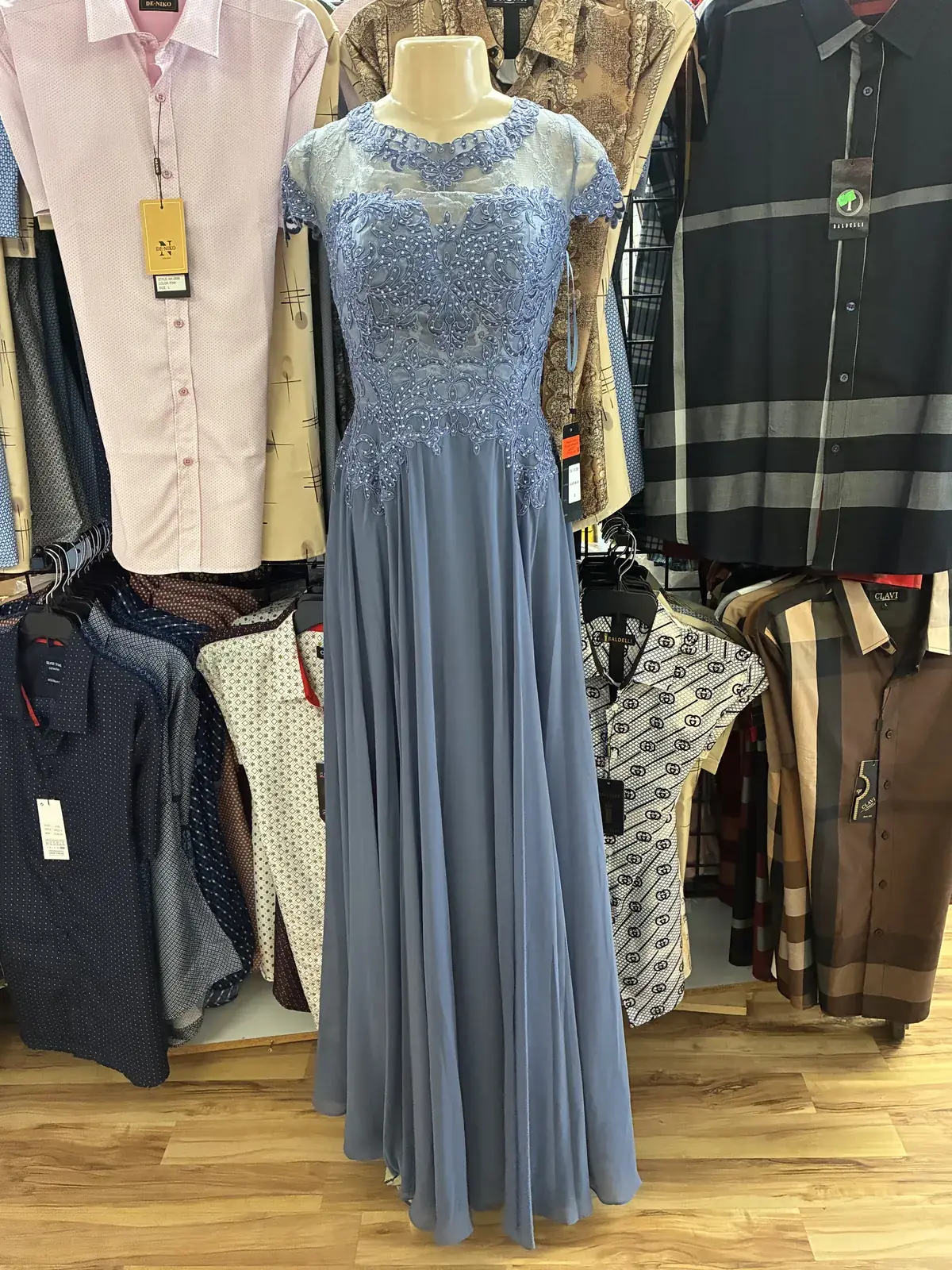 Dusty blue lace evening gown on display at Yessenia’s Fashion