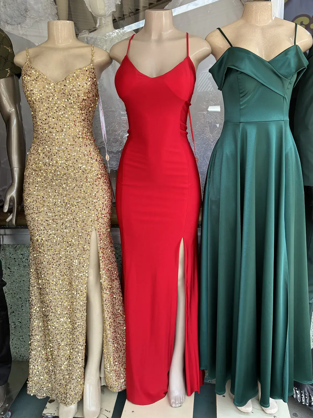 Gold, red & green evening gowns on display at Yessenia’s Fashion