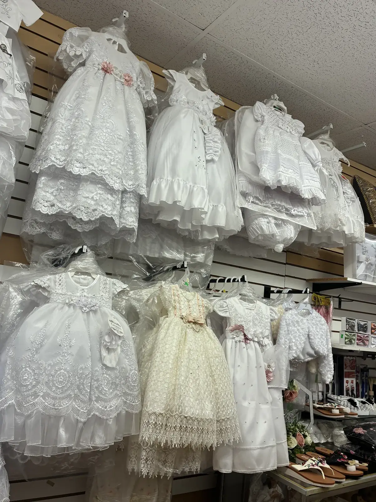 Lace baptism dresses on display at Yessenia’s Fashion