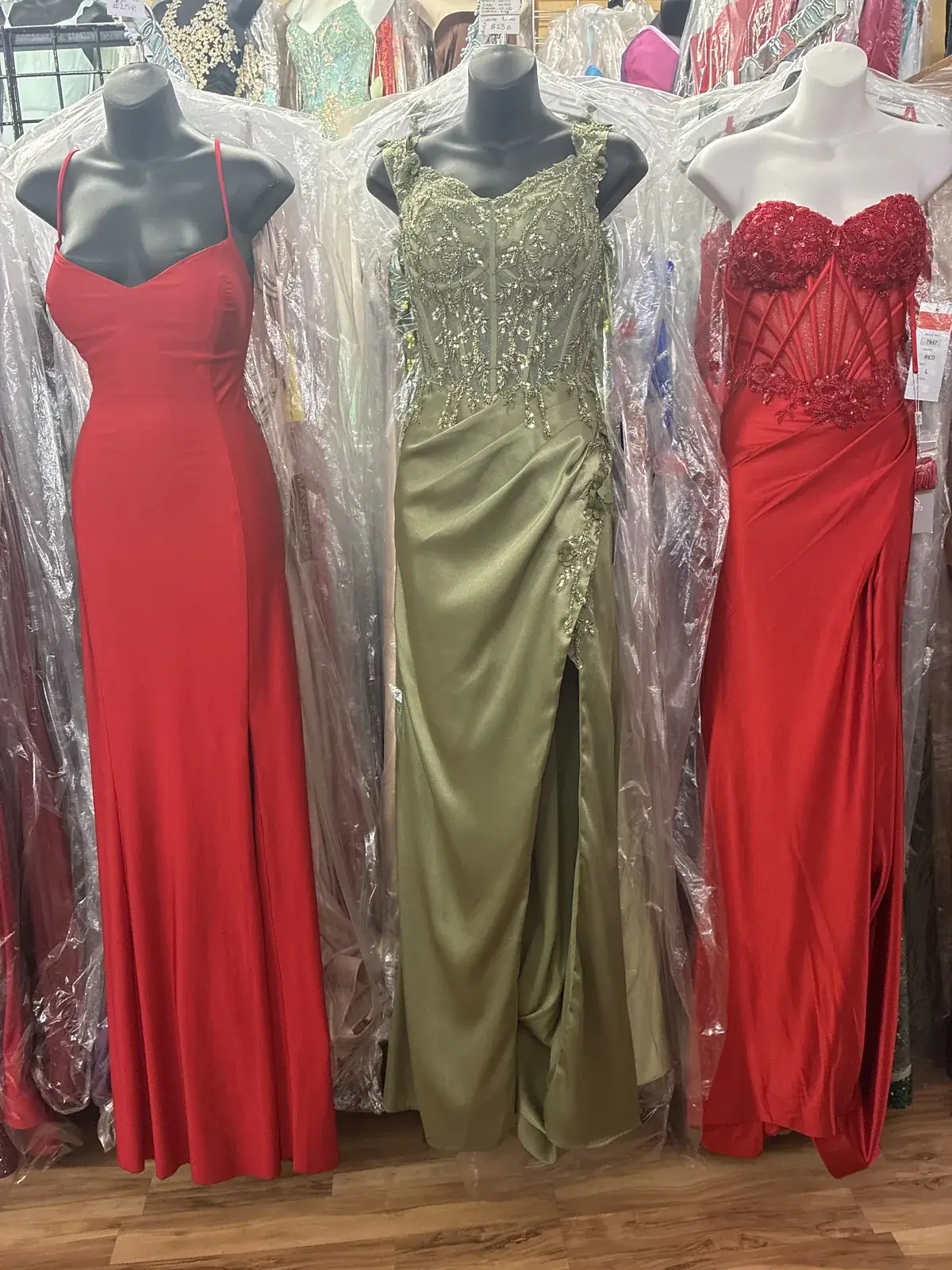Red, olive & red evening gowns on display at Yessenia’s Fashion