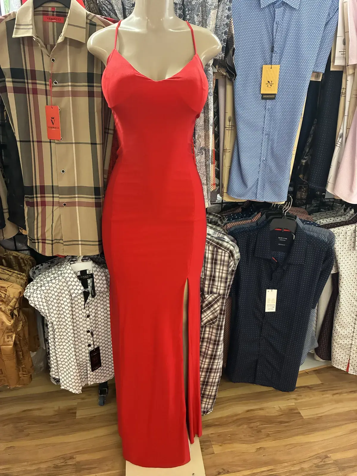 Red evening gown with side slit on display at Yessenia’s Fashion