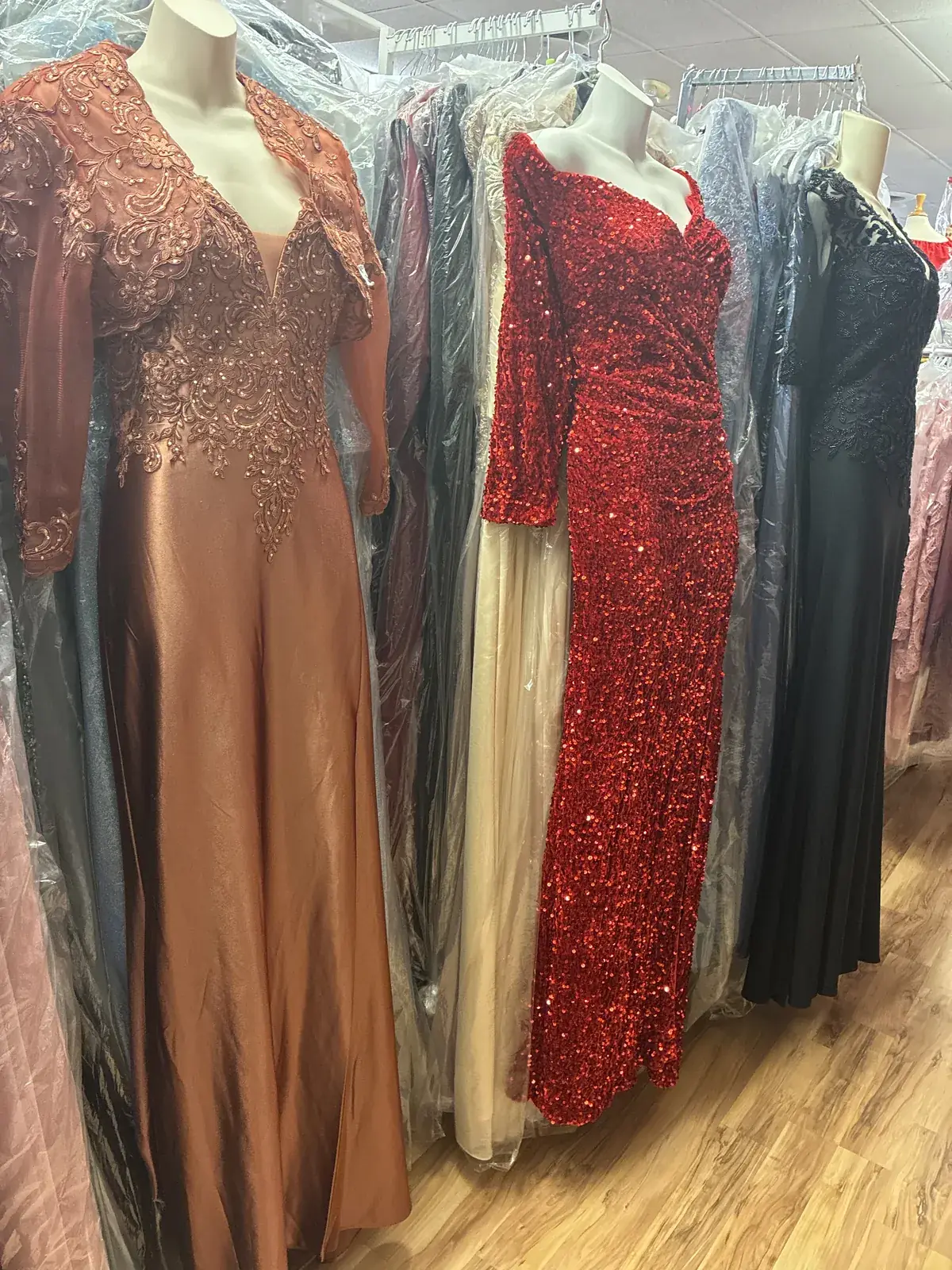 Rose gold & red sequin gowns on display at Yessenia’s Fashion