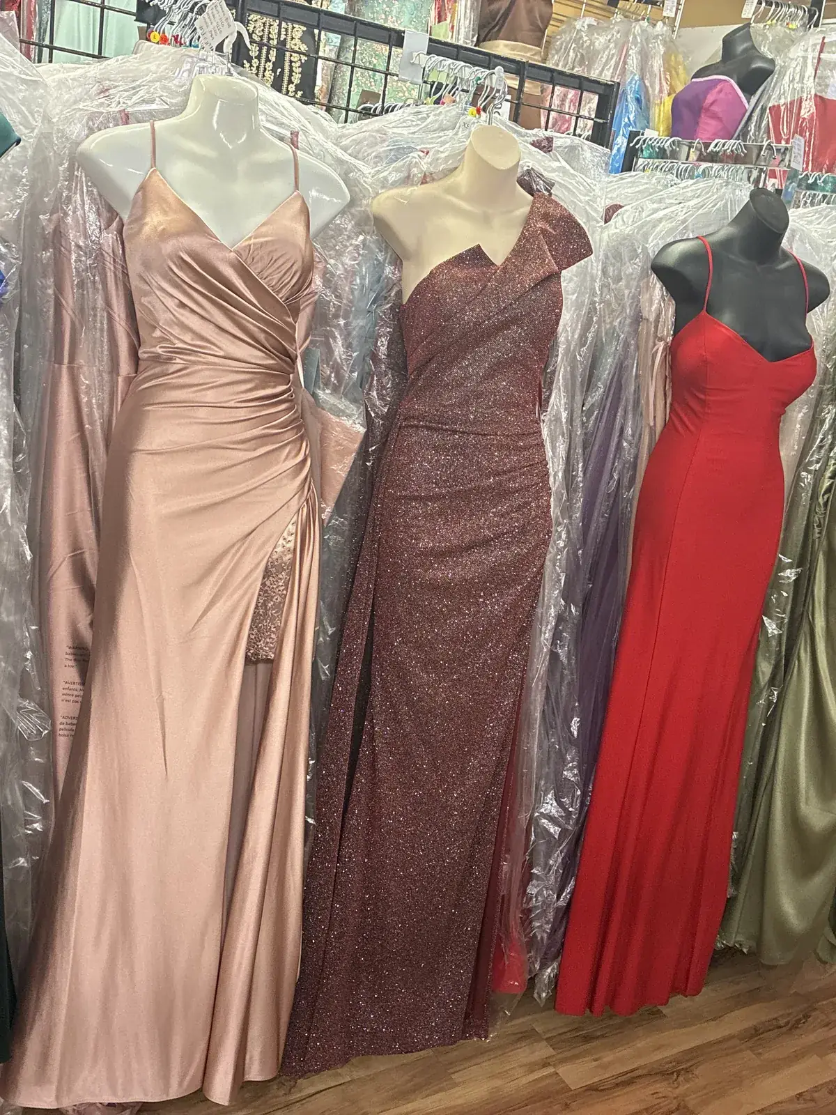 Satin evening gowns in every color on display at Yessenia’s Fashion